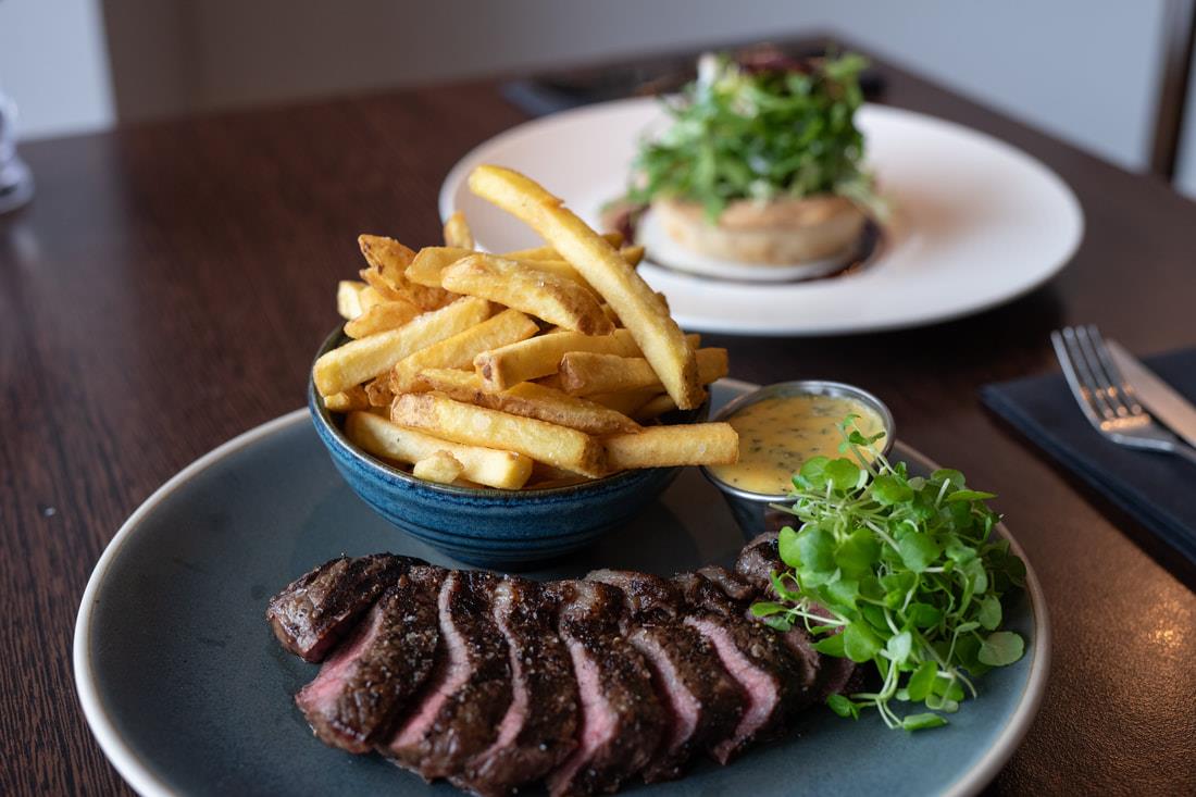 Grilled steak with hand-cut fries and peppercorn sauce
